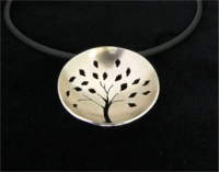 Nickel silver pendant with saw pierced design on PVC cord